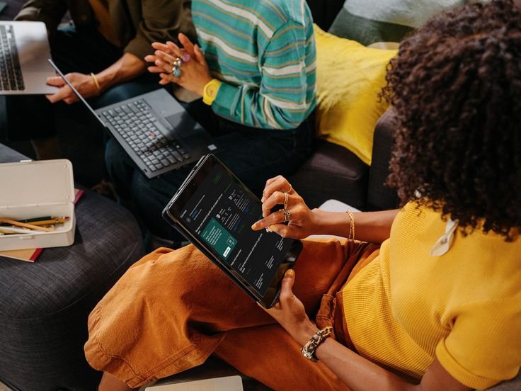 Creatives meeting with laptops and a tablet